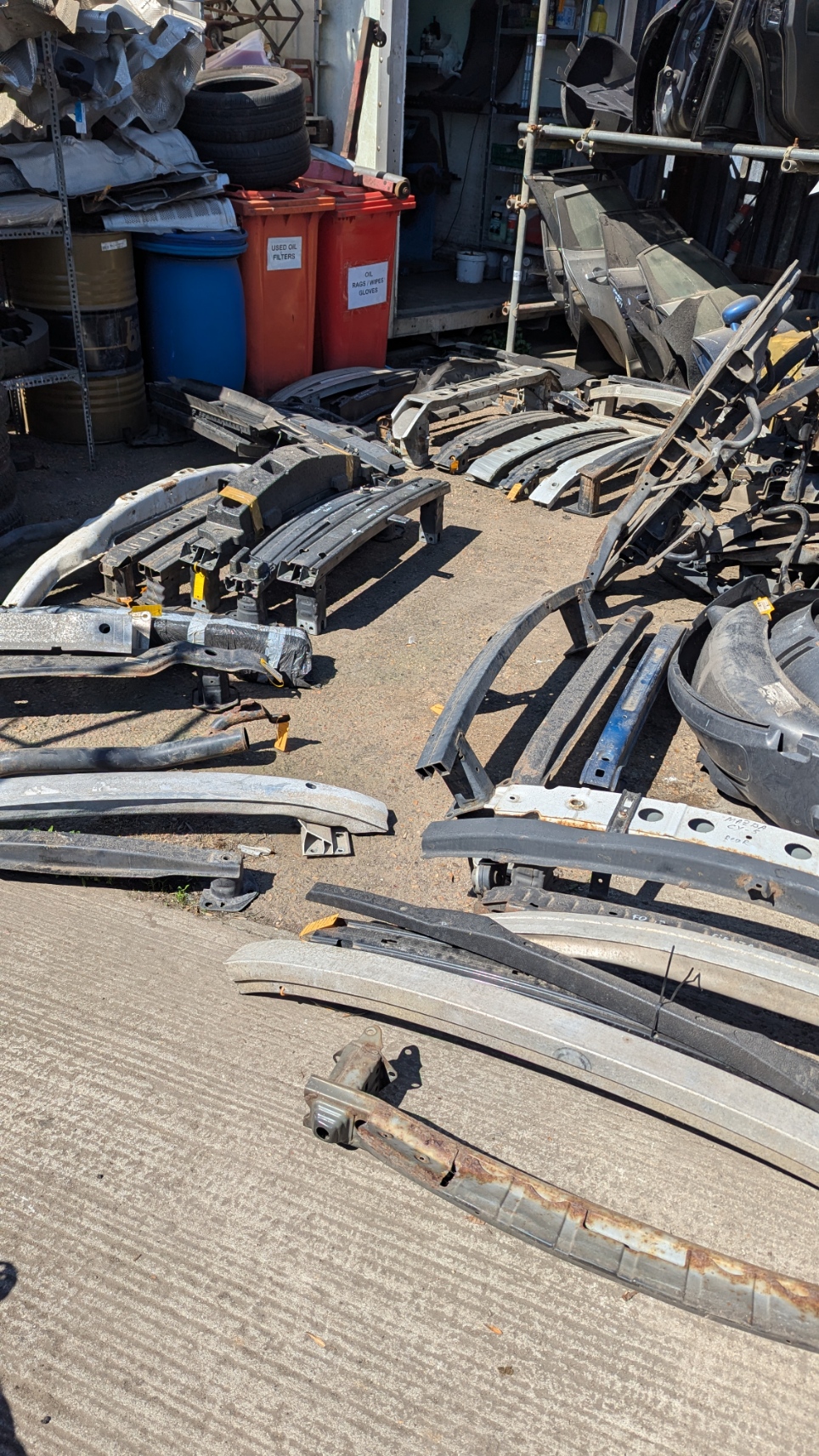Used bumper reinforcement bars laid out for sorting and identification — Amber Autos Essex