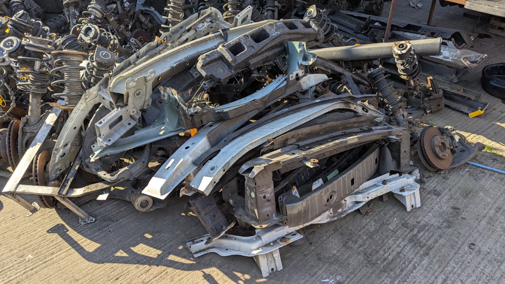Piles of used bumper reinforcement bars at Amber Autos Southend-on-Sea breakers yard