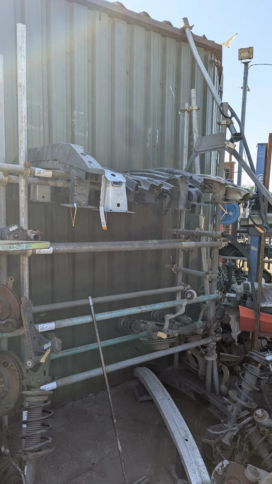 Sorted bumper reinforcement bars on labelled storage rack — Amber Autos Southend-on-Sea