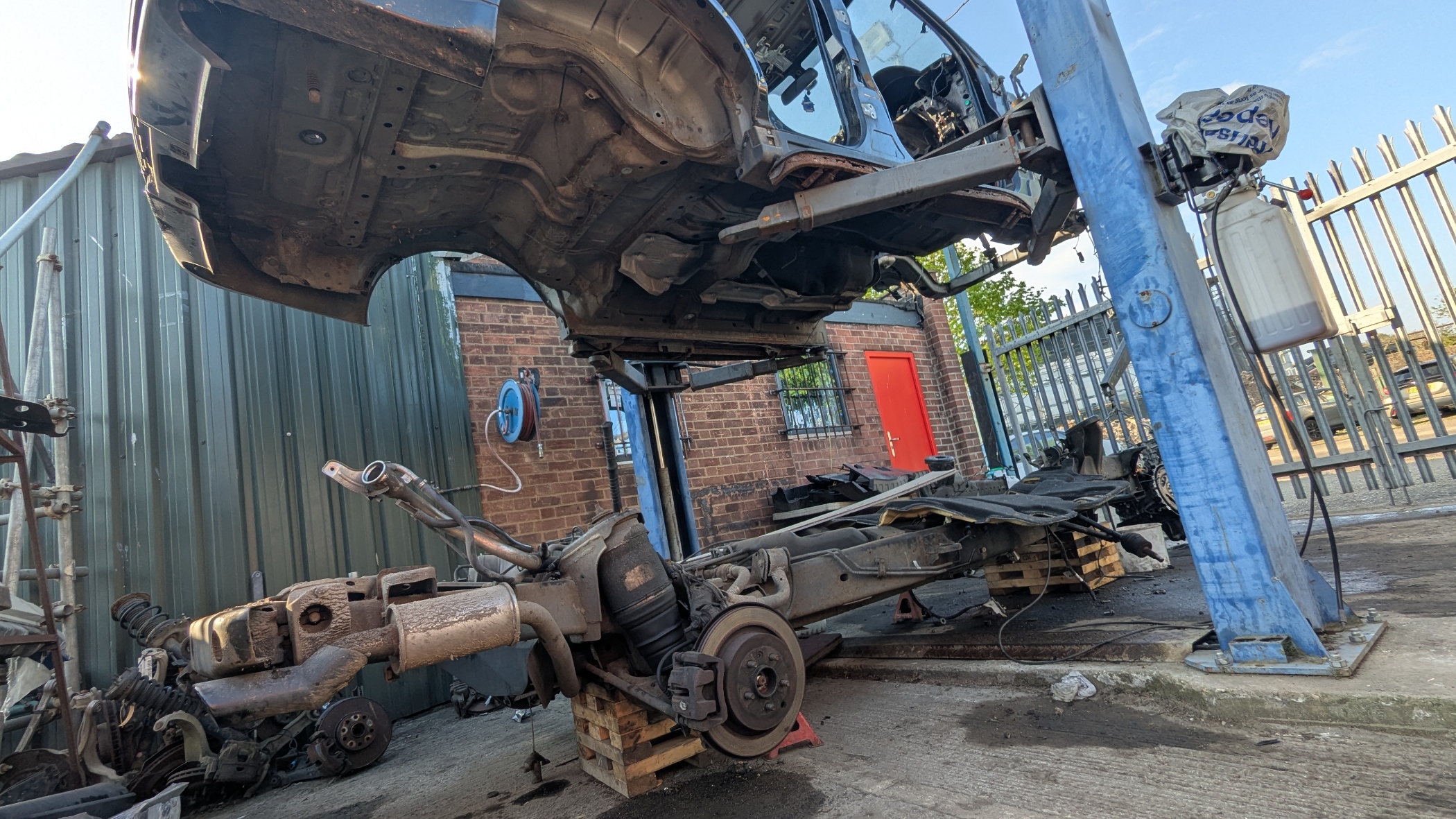 Range Rover Sport L320 body lifted off chassis — 276DT engine visible below at Amber Autos