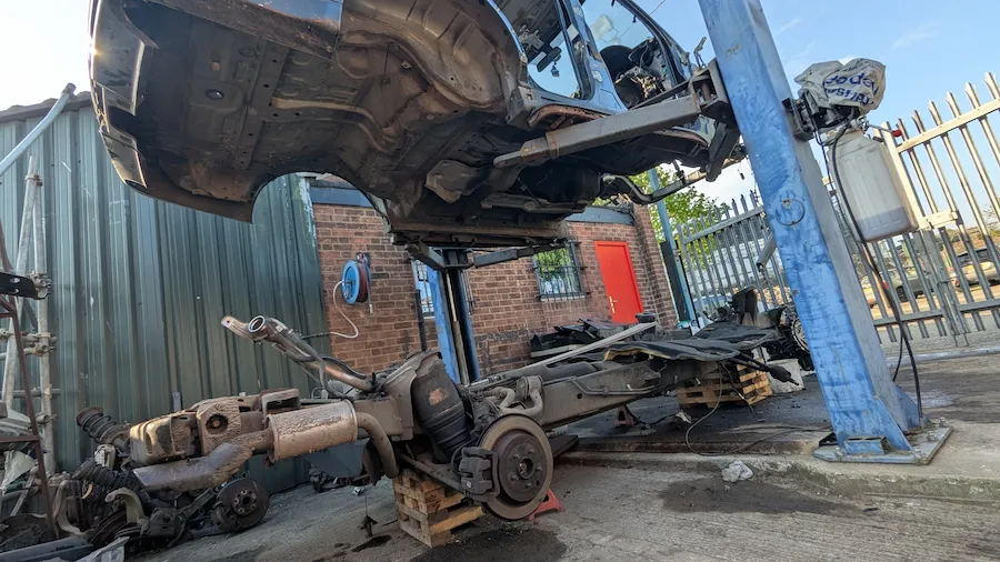 Range Rover Sport L320 body lifted off chassis — 276DT engine visible below at Amber Autos